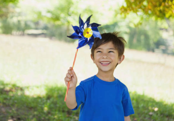 Child holding blue pinwheel